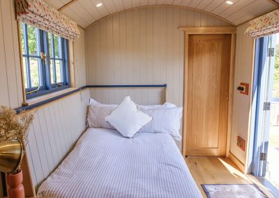 The pull out sofa bed inside the Mill Pond Shepherd's Hut